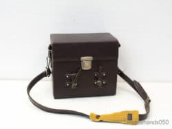 Classic dark brown leather bag with vibrant yellow strap for stylish everyday use.