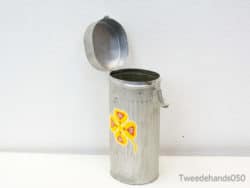 Charming vintage metal container with flower design, perfect for stylish storage or waste disposal.