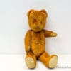 Vintage teddy bear with red eyes, symbolizing nostalgia and treasured childhood memories.