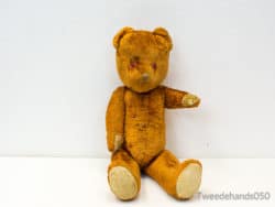 Vintage teddy bear with red eyes, symbolizing nostalgia and treasured childhood memories.