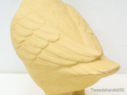 Charming yellow bird figurine with intricate feather details, ideal for nature-themed decor.