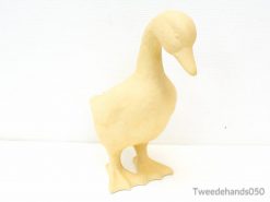 Whimsical yellow duck sculpture enhances modern decor with charm and elegance.