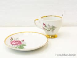 Elegant vintage teacup and saucer with pink roses and gold trim for tea parties.