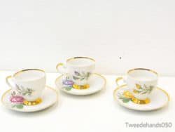 Vintage porcelain teacups with floral designs and gold trim, ideal for elegant tea gatherings.