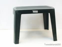 Durable black plastic stool with textured top, ideal for versatile indoor and outdoor use.