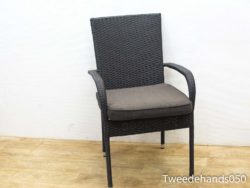 Stylish rattan dining chair with gray cushion, perfect for comfort in any elegant setting.