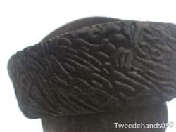 Elegant black headpiece with intricate patterns, celebrating cultural heritage and artistry.