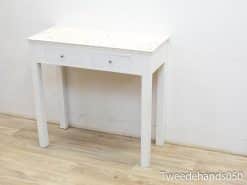 Sleek white console table with marble top and practical drawers for modern interior organization.