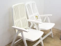 Modern white plastic chairs designed for comfort, ideal for relaxing indoors or outdoors.