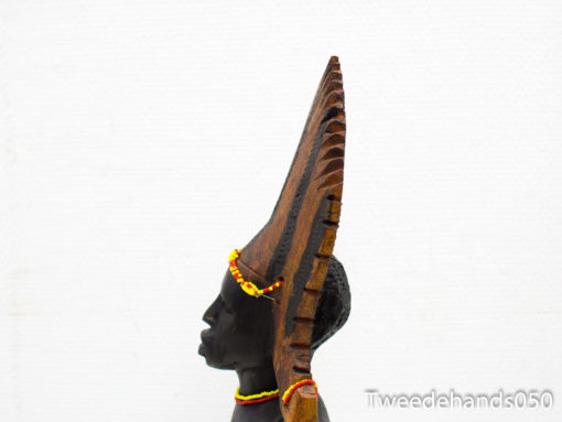 Elegant wooden sculpture with intricate headdress and colorful beads representing African cultural heritage.