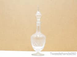 Stylish vintage glass decanter with intricate stopper for elegant serving and home decor.