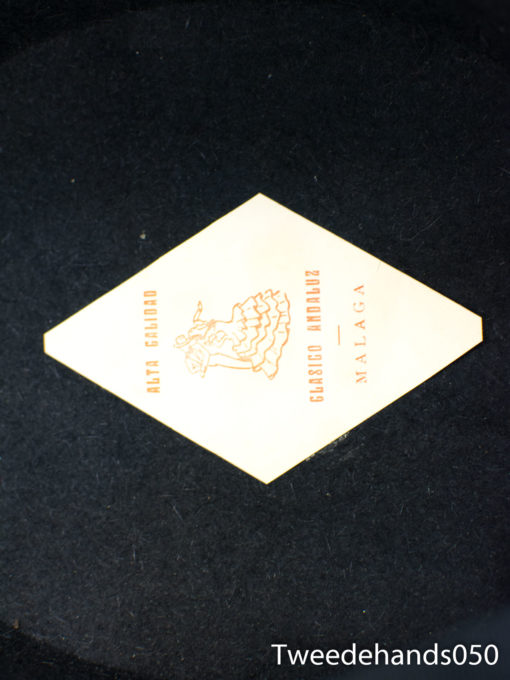 Elegant vintage diamond-shaped label from Café de Paris, Málaga, showcasing charm and sophistication.