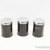 Chic black storage canisters with chrome lids, perfect for stylish organization in kitchens.