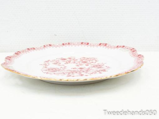 Elegant porcelain plate with red floral design and gold trim, ideal for collectors and decor.