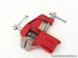 High-visibility red C-clamp for secure woodworking and metalworking applications.