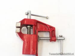 Sturdy red C-clamp for secure grip in woodworking and DIY projects. Ideal for precision work.