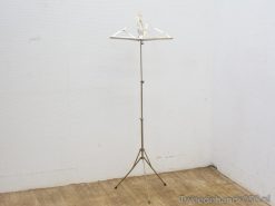 Stylish adjustable metal clothing rack for showcasing vintage fashion in homes and boutiques.