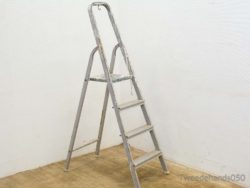 Stylish vintage aluminum ladder with four sturdy steps for home improvement and DIY projects.