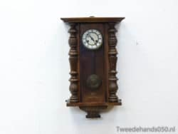 Elegant vintage wooden wall clock with ornate details and Roman numerals, perfect for classic decor.