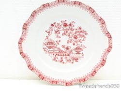 Elegant vintage porcelain plate featuring vibrant red floral designs with scalloped edges.