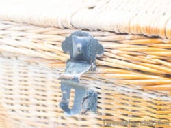 Vintage wicker basket with metal latch for stylish storage and rustic home decor.