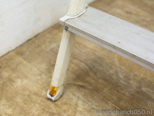 Charming weathered white wooden ladder, perfect for decor and functional home projects.