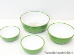 Vintage green mixing bowls with white interiors, perfect for cooking and charming kitchen decor.