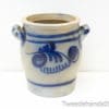 Elegant beige ceramic pot with blue patterns, perfect for decor or plant display.