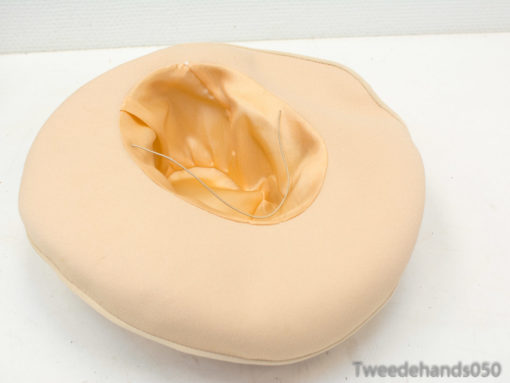 Peach ergonomic cushion with a central indentation for ultimate comfort and support.