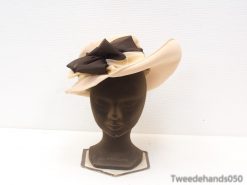 Elegant beige hat with luxurious dark brown bow, ideal for weddings and special occasions.