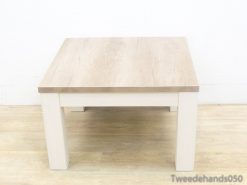 Stylish light wood table with white legs, perfect for modern and cozy spaces.