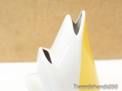 Contemporary yellow and white ceramic vase with peaks, ideal for modern floral arrangements.