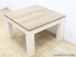 Elegant light wood coffee table with sturdy white legs, perfect for modern minimalist spaces.