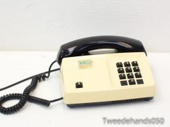 Charming 1960s black and cream vintage telephone, perfect for retro decor and collectors.