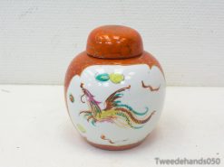 Colorful dragon porcelain jar with orange lid, perfect for decor or unique gifts.