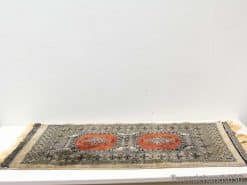 Handwoven vintage rug featuring vibrant orange octagons and intricate patterns for stylish interiors.