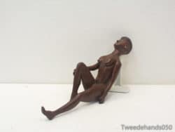 Stylized seated female figurine, ideal for adding elegance to contemporary decor.