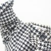 Sophisticated houndstooth jacket with elegant collar and rolled sleeves for versatile styling.