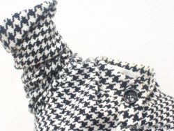 Sophisticated houndstooth jacket with elegant collar and rolled sleeves for versatile styling.