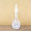 Elegant crystal decanter with floral designs, ideal for upscale beverage service and decor.