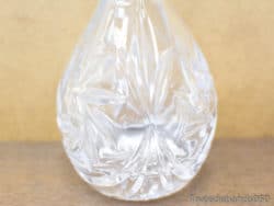 Elegant crystal decanter with intricate leaf designs, perfect for sophisticated home decor and entertaining.