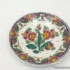 Vibrant hand-painted floral plate with elegant border, perfect for decoration or serving.