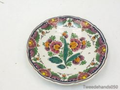 Vibrant hand-painted floral plate with elegant border, perfect for decoration or serving.