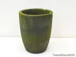 Unique green cylindrical pot with rustic charm, ideal for home and garden decoration.