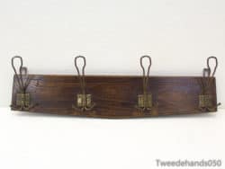 Rustic dark wood coat rack with vintage brass hooks, perfect for stylish entryway organization.