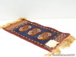 Intricate blue vintage rug with elegant orange and cream patterns, perfect for stylish interiors.