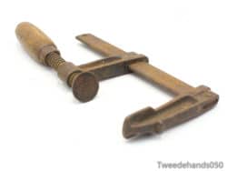 Antique woodworking clamp with wooden handle, ideal for DIY projects and vintage tool collectors.