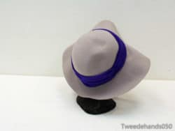 Chic beige wide-brim hat with vibrant purple band, perfect for any stylish occasion.