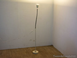 Sleek modern floor lamp with white shade, perfect for cozy minimalistic spaces.