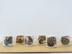 Whimsical ceramic mugs featuring colorful illustrations that celebrate joy and community togetherness.